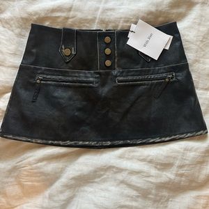 NWT With Jean mini leather skirt with brass gold hardware.